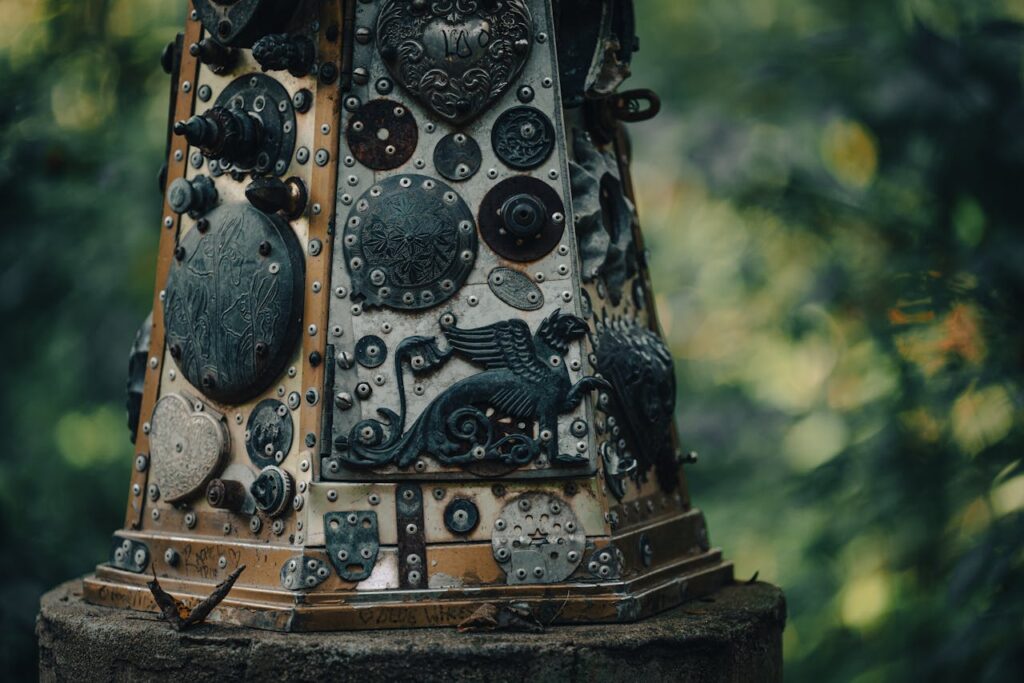 pexels photo 10045897 Detailed close-up of a metallic sculpture with intricate designs in an outdoor setting.